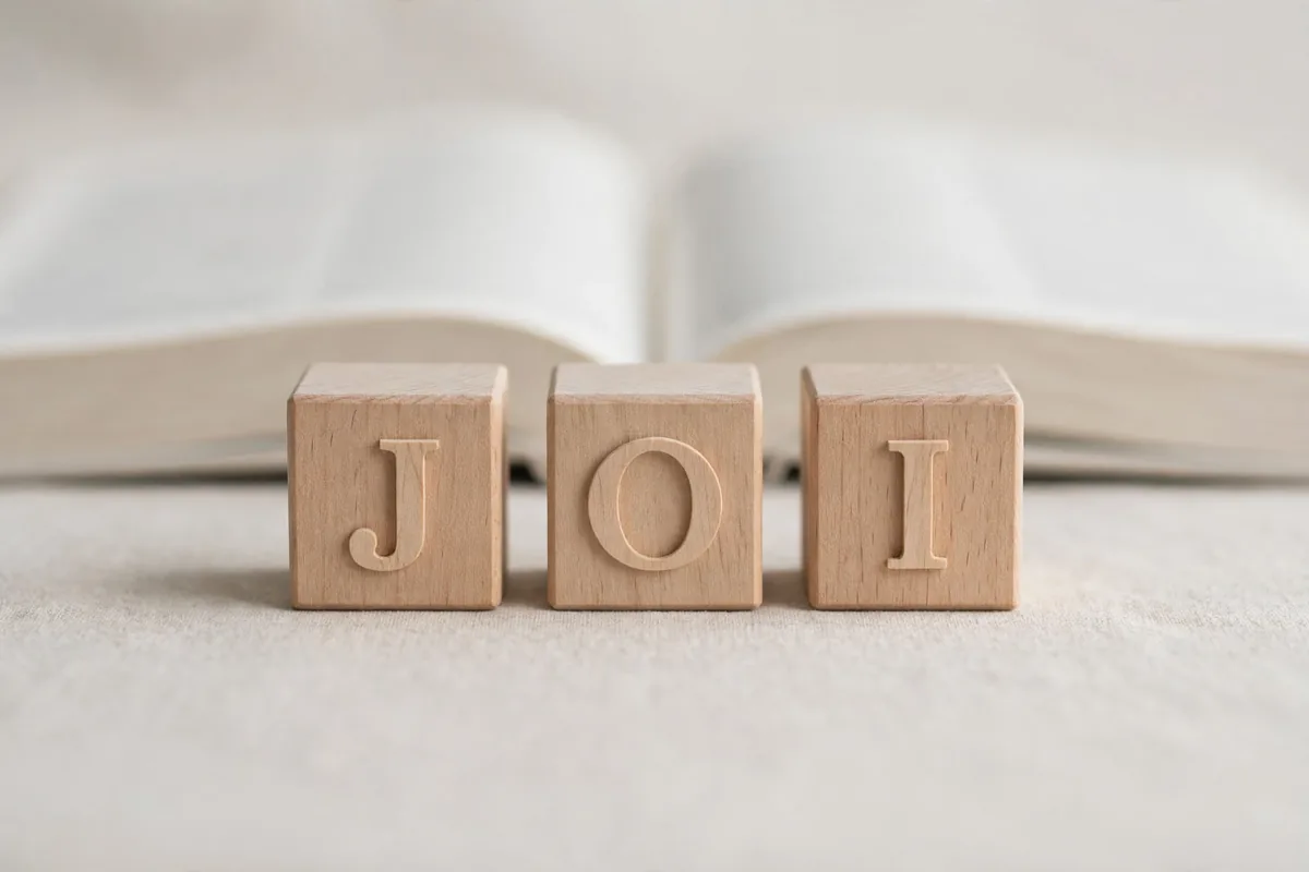 JOI meaning acronym - wooden letter blocks spelling JOI representing abbreviation definition