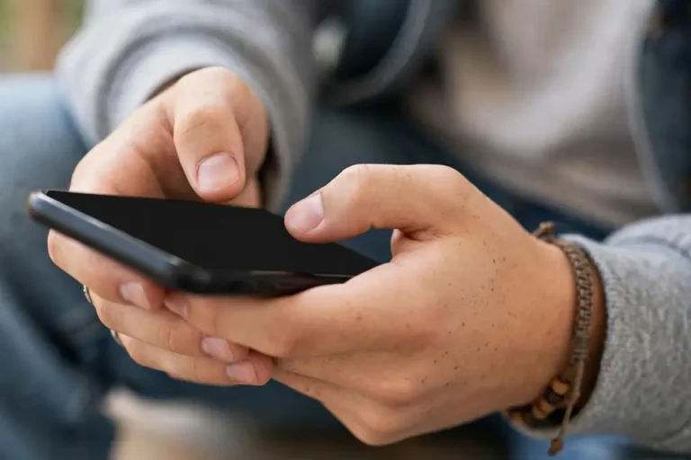 WYS meaning - person texting on smartphone